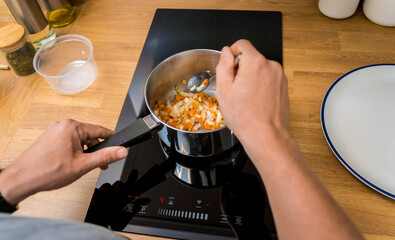 Chef at the kitchen preparing healthy quinoa bowl with avocado