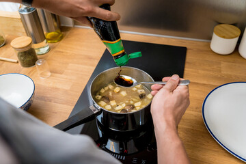 Chef at the kitchen preparing healthy quinoa bowl with avocado