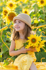 Cheerful Girl in a Yellow Dress Holding Sunflowers in a Vibrant Field During Sunny Afternoon