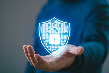 Person holding a digital shield with a lock symbol, representing cybersecurity, data protection,...