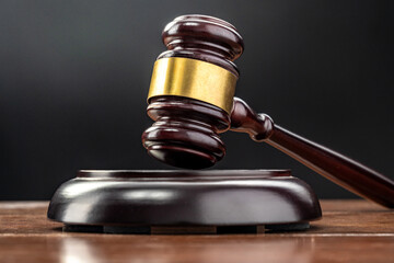 Judge's gavel on a table welly lit with black background