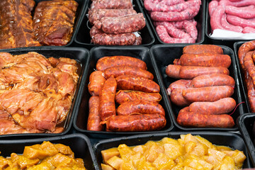 raw meat for sale in a butcher shop. There is spicy chorizo, sweet chorizo, sausages, red meat and spicy chicken