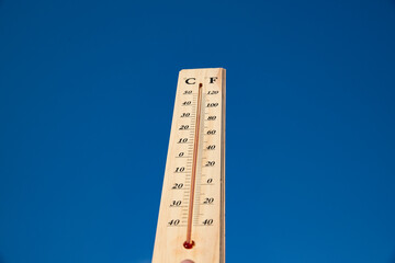 Thermometer shows high temperature in summer heat