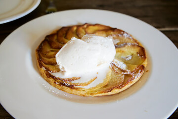 Apple pie. A plate with apple pie and a scoop of ice cream