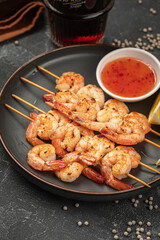 Portion of shrimp skewers with sweet and sour sauce