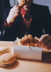 close up focus woman hand hold fried chicken for eat,girl with fast food concept
