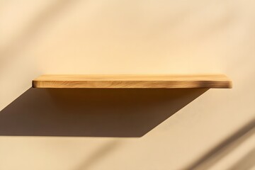 Minimalist beige wall background with a wood shelf for product presentation