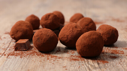 dark chocolate truffles on wooden background