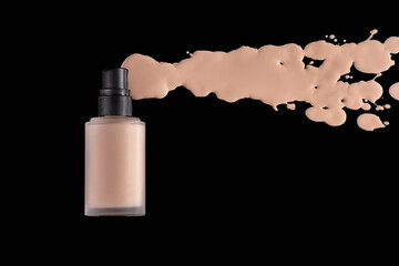 Spilled Liquid foundation. Mockup glass bottle of foundation cosmetic product on black background,...
