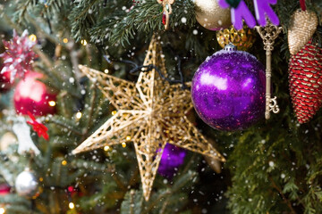 Beautiful festive decorations on the Christmas tree. Close-up. Beautiful Christmas background. The concept of decorations and decor for the new year. New Year's Card 2025