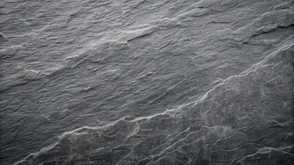 Naklejka premium Dark grey slate stone texture with subtle scratches and veins, showcasing a rugged and weathered appearance with a matte finish and neutral background.