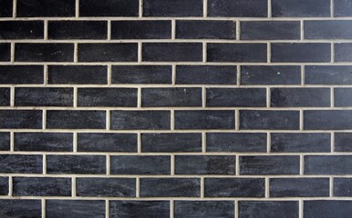 Real black brick wall. Black bricks