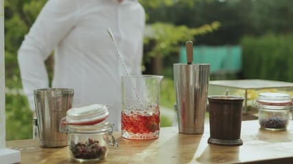 Expert bartender crafts cocktails, man sips refreshing drink with straw