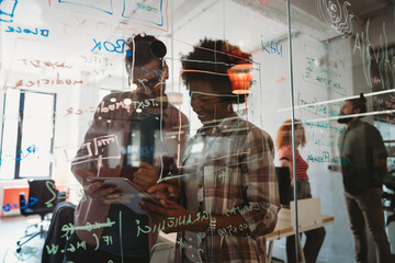 Team of programmers writing digital code in the metaverse and working together on the internet