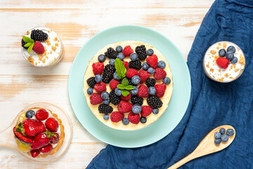 Homemade cake with fresh berries on wooden background.