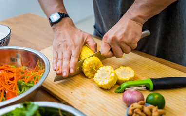 Chef at the kitchen preparing spicy glass noodle salad