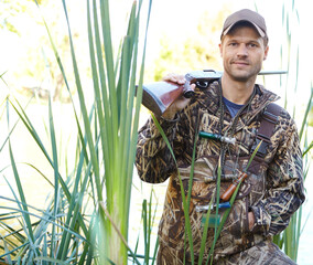 Man, gun and portrait with gear outdoor for camouflage, hunting wildlife or adventure activity of nature safety. Male hunter, rifle and security for birdwatching, hobby and gaming target of survival