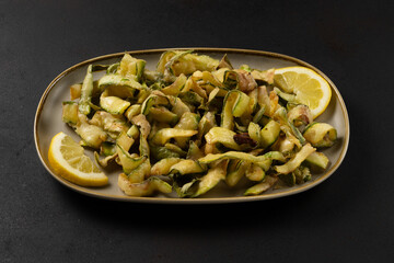 Closeup view of grilled zucchini on plate.