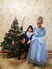 new year, christmas, children standing by the new year tree, snowman, holidays, childhood, boy, winter, girl, mom, mother, new year decor, cinderella, musketeer, horse, new year outfits, masquerade