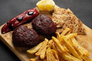 Greek mediterranean cuisine. XL beef patty made from minced meat with fried potatoesm, pepper, pita and yogurt dip.