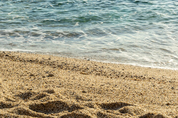 Beach sand on sea background. Summer vacation background. Selective focus.