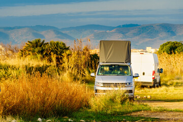 Van with roof top tent camping on nature