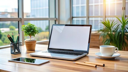 Modern laptop screen displaying a blank empty template on a wooden desk surrounded by office supplies and a cup of coffee in a bright studio.