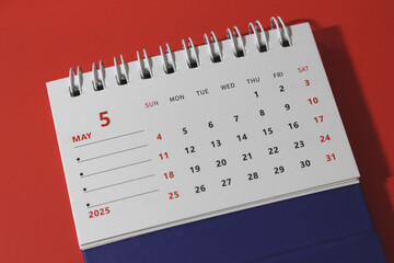 Monthly calendar template for the new year 2025 desk calendar,on red background.