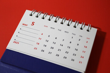 Monthly calendar template for the new year 2025 desk calendar,on red background.