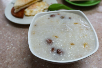 close up of Chinese Cantonese style boiled peanut and pork congee 