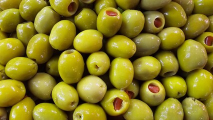 Close-Up of Juicy Olives in Various Colors - Green, Black, Purple, Red, Pink, and Brown Olives market