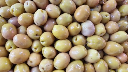 Close-Up of Juicy Olives in Various Colors - Green, Black, Purple, Red, Pink, and Brown Olives market
