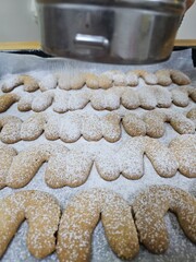 Buttery Crescent-Shaped Cookies with Powdered Sugar on Baking Sheet or in Box