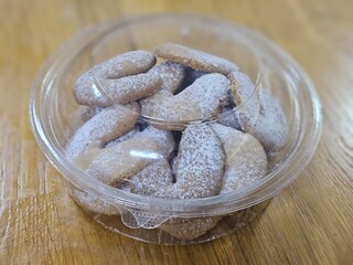 Buttery Crescent-Shaped Cookies with Powdered Sugar on Baking Sheet or in Box