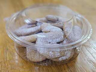 Buttery Crescent-Shaped Cookies with Powdered Sugar on Baking Sheet or in Box
