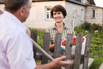 Farm neighbors talking at the fence