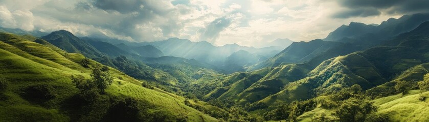 Breathtaking panoramic view of lush green mountains under a dramatic sky, showcasing nature's serene beauty and vibrant colors.