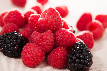 Fresh raspberry and blackberry berries on white background