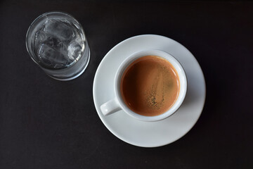 Hot coffee is black coffee in a glass on the table, ready to drink.