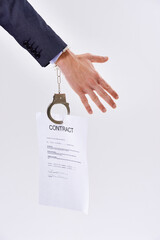 Business person, contract and handcuffs with chain for job or career bound in studio on a white...
