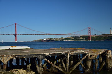 Obraz premium Suspension bridge crossing the river Tagus in Lisbon Portugal. The 25 de Abril Bridge. 