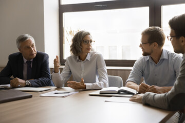 Businesslady hold formal meeting event with shareholders. Four young and middle-aged professionals...