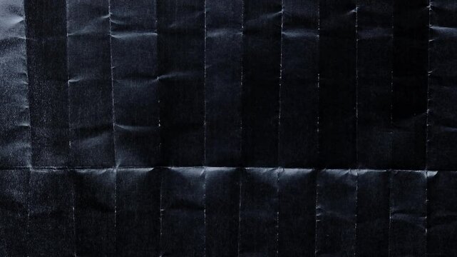 led light is moving over a dark paper surface or texture with black ink on it, paper with folding marks, nice paper video overlay via blend mode in 4k.