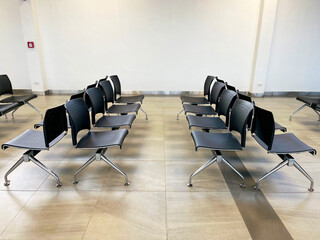  rows of airport chairs in a modern terminal, clean, sleek design of seating arrangements often seen in airports, providing a calm and organized environment,  travel, transportation, airport design