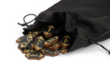 Wooden runes with sack isolated on white background. 