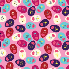 A pink background with a pattern of faces and lips. The faces are all different colors and sizes, and the lips are pink. Scene is playful and whimsical