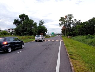 Car passing street bump with yellow lines as the mark of the street bump 