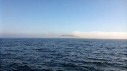 Fototapeta premium Island in the Mist on a Blue Ocean