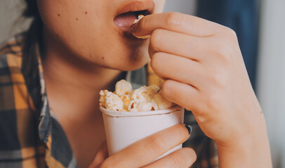 A woman holding a bowl of popcorn