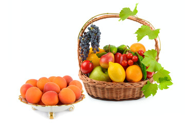 Ripe apricots in a porcelain plate and a set of vegetables and fruits in a wicker basket isolated on a white. Collage.